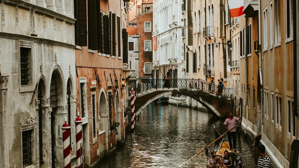Gondolas floating on a canal between historic buildings in Venice, Italy