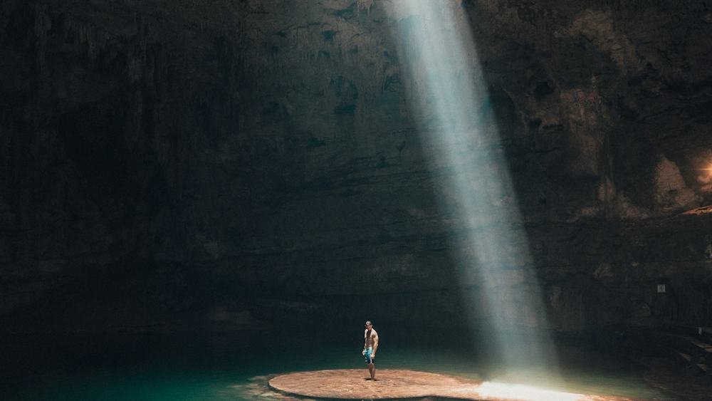 Sunlit cenote in Yucatan, Mexico, a popular natural swimming spot near Merida