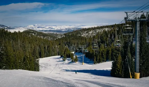 Snow-covered ski run and lift in the Colorado mountains during winter ski season