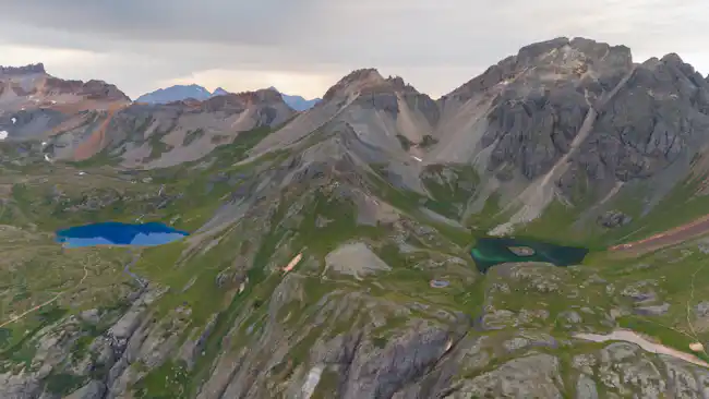 Turquoise alpine lake surrounded by mountains in Colorado during summer
