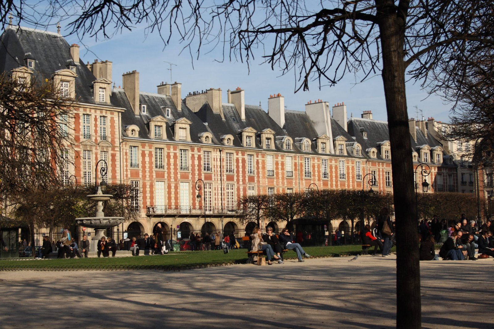 Place des Vosges square in Le Marais, Paris, lined with historic red-brick buildings