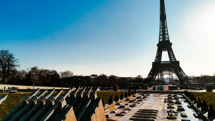 Fountain and Eiffel Tower under a clear blue sky in Paris during spring