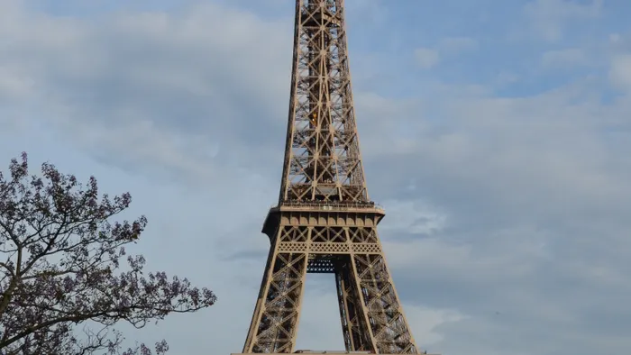 Eiffel Tower under a serene blue sky in Paris during summer