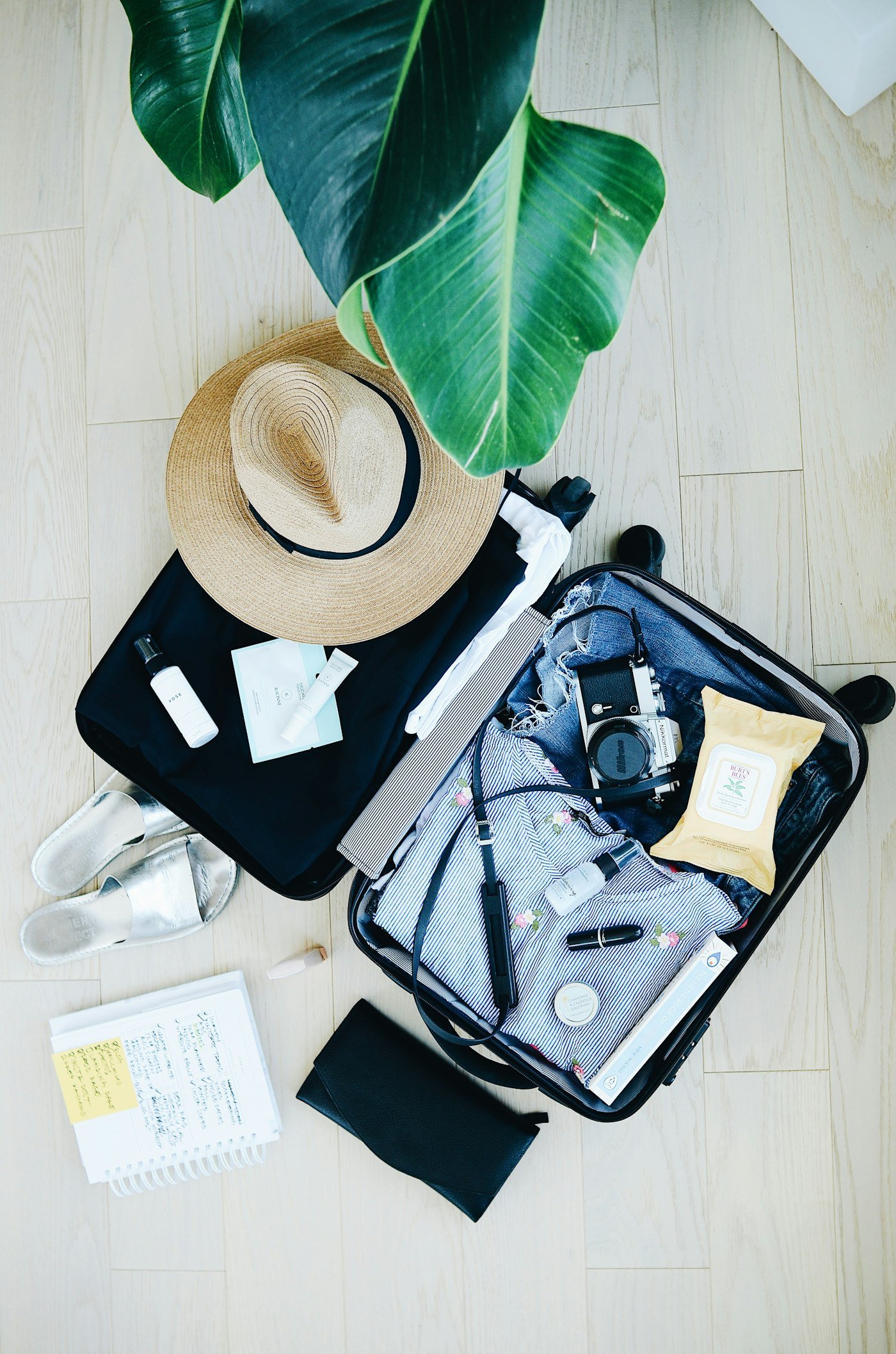 Traveler standing beside packed luggage, representing booking tips for Savannah luxury hotels