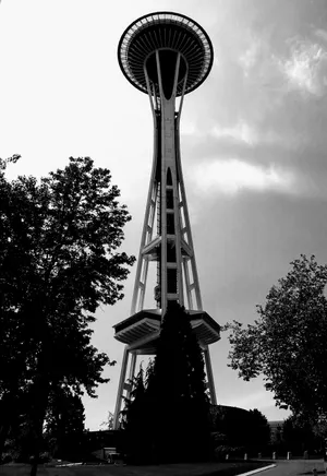 Vertical view of Seattle's Space Needle against a cloudy sky